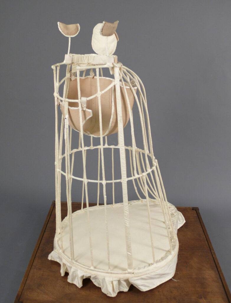 Punk in Art: Steampunk, Dieselpunk, Cyberpunk. Erin Colleen Williams, Dancing Dress for a Legless Girl, hand-sewn silk, steel, leather, antique casters, Part of the Minnie Eureka Young series, A History Revealed (2006-2008). ©Erin Colleen Williams.