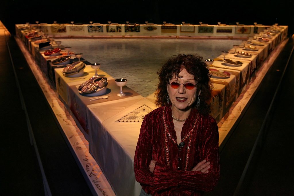 Dinner Party judy chicago: Judy Chicago in front of The Dinner Party, Elizabeth A. Sackler Center for Feminist Art at the Brooklyn Museum, New York, NY, USA, 2018. Photo by Sara Krulwich/The New York Times.